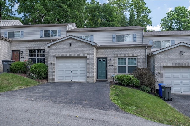 108 Arthur Ct, Richland, PA 15044 - townhome / multi-family property featuring asphalt driveway, brick siding, a front yard, and an attached garage