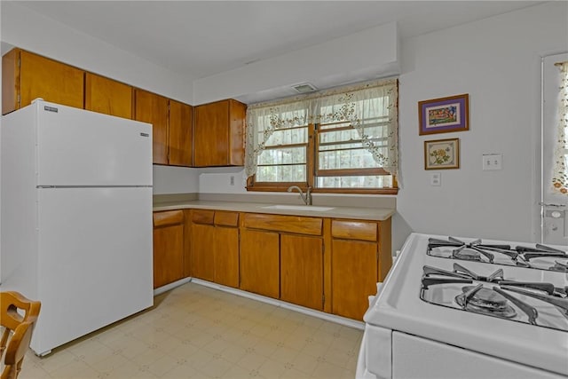 320 Wilson Ave, Beaver, PA 15009 - kitchen with white appliances, light countertops, light floors, and brown cabinetry