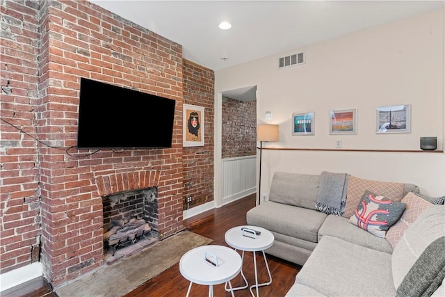 175-177 43rd 1/2 St, Lawrenceville, PA 15201 - living area featuring wood finished floors, a brick fireplace, wainscoting, and recessed lighting