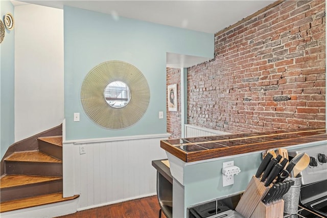 175-177 43rd 1/2 St, Lawrenceville, PA 15201 - stairs featuring brick wall, wood finished floors, and wainscoting