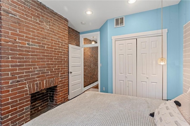 175-177 43rd 1/2 St, Lawrenceville, PA 15201 - bedroom featuring brick wall, a closet, a fireplace, and recessed lighting