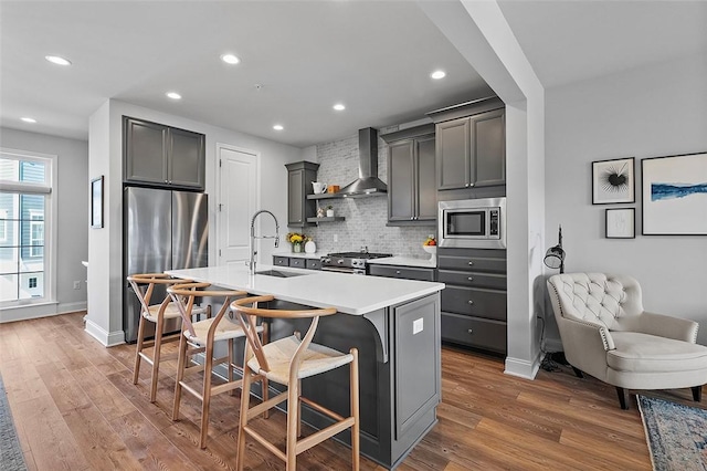 3155 Preston Way, Bridgeville, PA 15017 - kitchen featuring wall chimney exhaust hood, stainless steel appliances, backsplash, recessed lighting, and wood finished floors