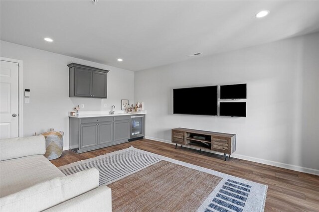 3155 Preston Way, Bridgeville, PA 15017 - living room featuring beverage cooler, bar with sink, dark wood-style flooring, and recessed lighting