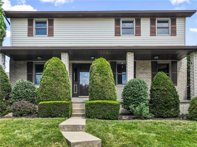 358 Shannon Cir, Daugherty Twp, PA 15066 - view of front of property with covered porch, brick siding, and a front yard