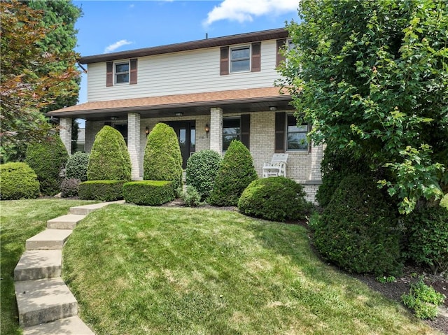 358 Shannon Cir, Daugherty Twp, PA 15066 - view of front of home with brick siding, a front lawn, and a porch