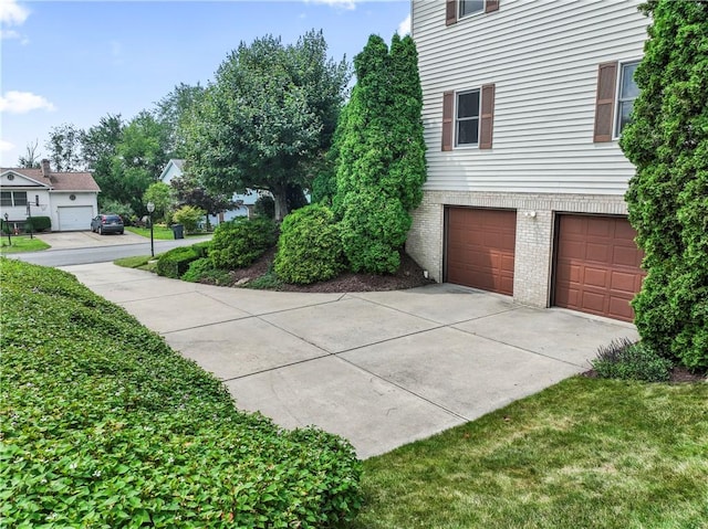 358 Shannon Cir, Daugherty Twp, PA 15066 - view of home's exterior featuring brick siding, an attached garage, and driveway