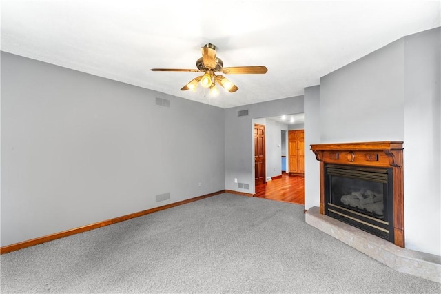 358 Shannon Cir, Daugherty Twp, PA 15066 - unfurnished living room featuring carpet flooring, a glass covered fireplace, and a ceiling fan