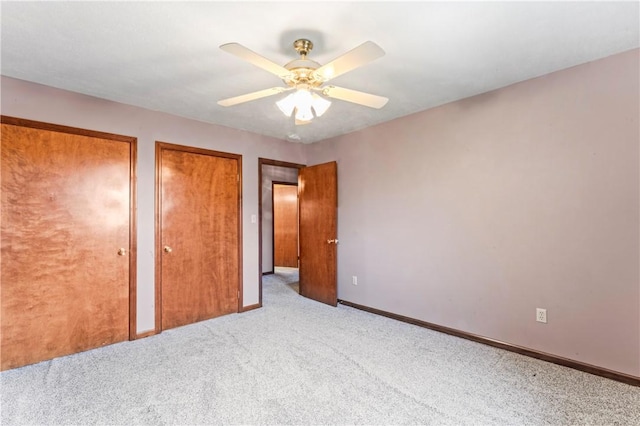 358 Shannon Cir, Daugherty Twp, PA 15066 - unfurnished bedroom with two closets, carpet, and a ceiling fan