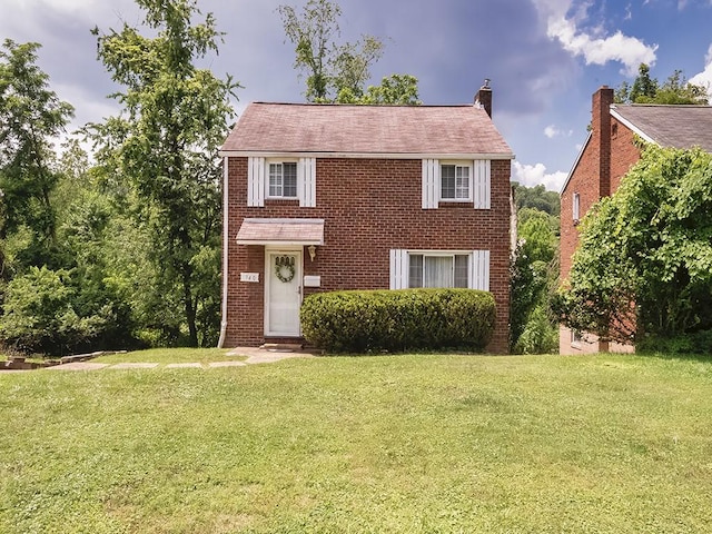 740 Churchill Ave, Penn Hills, PA 15235 - view of front of property featuring a front yard, brick siding, and a chimney