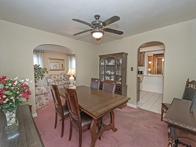 740 Churchill Ave, Penn Hills, PA 15235 - dining space with arched walkways, light colored carpet, a ceiling fan, and light tile patterned flooring