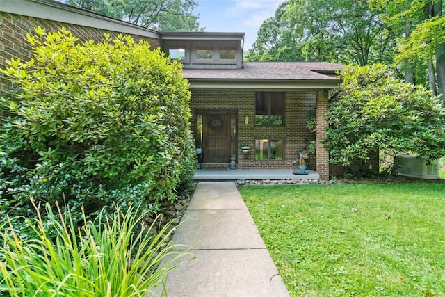 268 Glade Mills Rd, Middlesex Twp, PA 16059 - view of exterior entry featuring brick siding, covered porch, and a yard