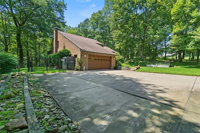 268 Glade Mills Rd, Middlesex Twp, PA 16059 - view of side of home with brick siding, driveway, a chimney, a garage, and a gate