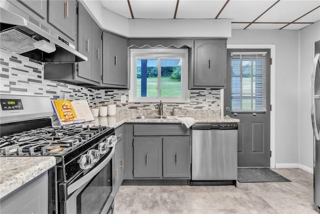 880 Patton St, Monroeville, PA 15146 - kitchen with stainless steel appliances, gray cabinets, under cabinet range hood, and plenty of natural light