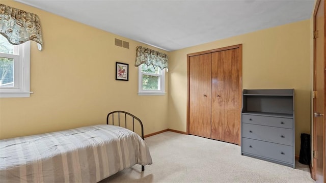 77 Ridgecrest Dr, Wilkins Twp, PA 15235 - bedroom featuring multiple windows, light carpet, and a closet