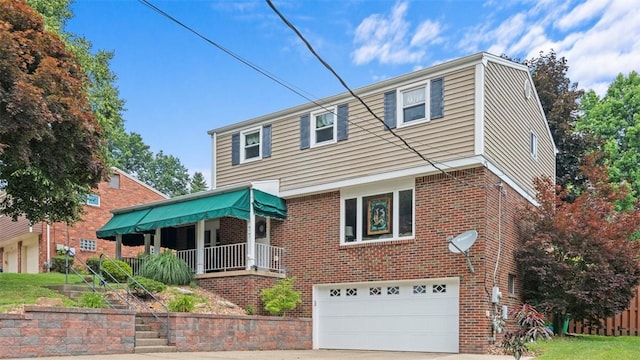 77 Ridgecrest Dr, Wilkins Twp, PA 15235 - colonial inspired home with brick siding, a garage, driveway, and covered porch