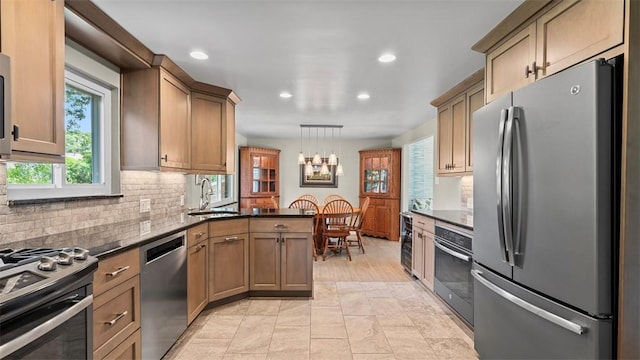 77 Ridgecrest Dr, Wilkins Twp, PA 15235 - kitchen featuring stainless steel appliances, recessed lighting, backsplash, a chandelier, and pendant lighting