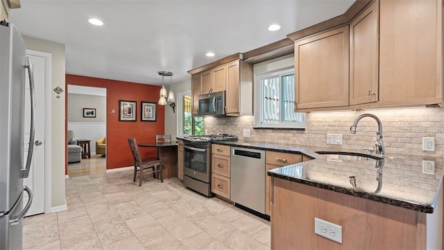 77 Ridgecrest Dr, Wilkins Twp, PA 15235 - kitchen featuring appliances with stainless steel finishes, dark stone counters, backsplash, hanging light fixtures, and recessed lighting