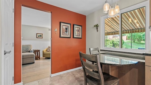 77 Ridgecrest Dr, Wilkins Twp, PA 15235 - dining area with a chandelier and a wainscoted wall