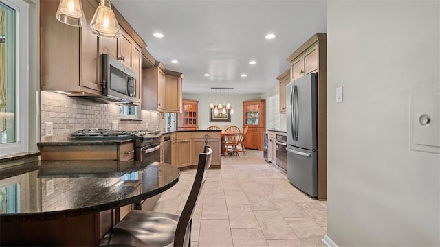 77 Ridgecrest Dr, Wilkins Twp, PA 15235 - kitchen featuring stainless steel appliances, recessed lighting, tasteful backsplash, dark countertops, and hanging light fixtures
