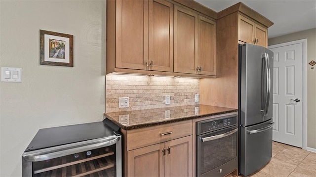 77 Ridgecrest Dr, Wilkins Twp, PA 15235 - kitchen with freestanding refrigerator, oven, tasteful backsplash, dark stone counters, and range
