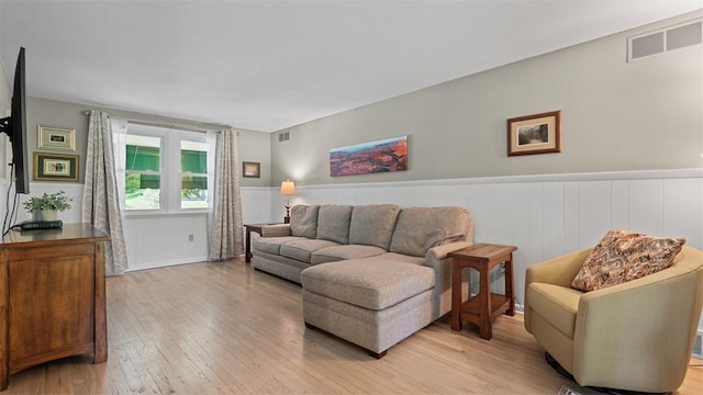 77 Ridgecrest Dr, Wilkins Twp, PA 15235 - living area with light wood-style floors and a wainscoted wall