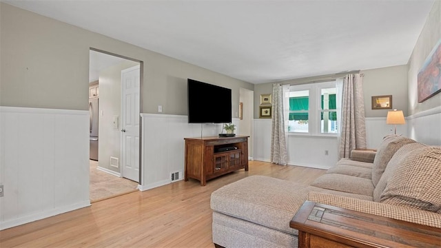 77 Ridgecrest Dr, Wilkins Twp, PA 15235 - living area featuring light wood-type flooring and wainscoting