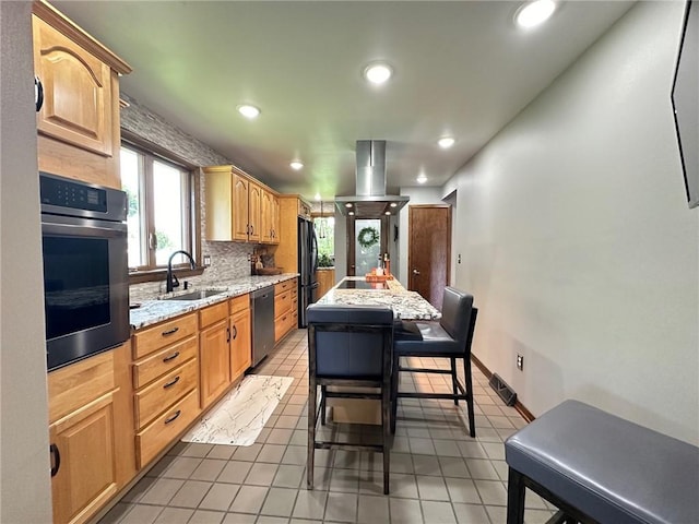 132 Terrace Dr, North Sewickley Twp, PA 16117 - kitchen featuring appliances with stainless steel finishes, recessed lighting, a center island, light stone counters, and light tile patterned floors