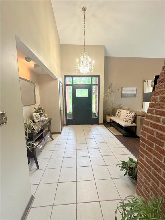 132 Terrace Dr, North Sewickley Twp, PA 16117 - entryway with a chandelier, a high ceiling, and light tile patterned floors