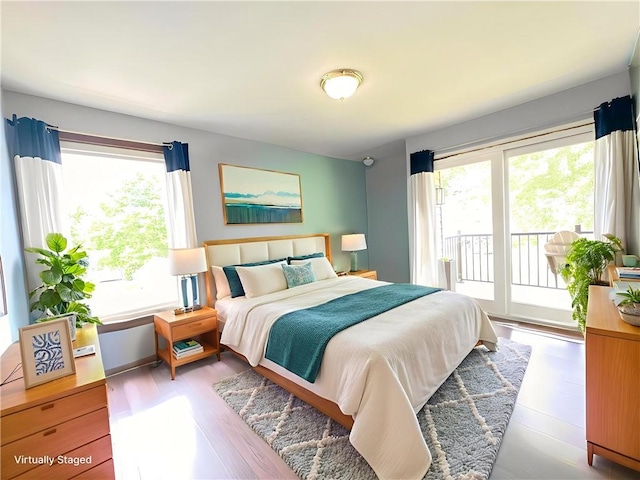 132 Terrace Dr, North Sewickley Twp, PA 16117 - bedroom with multiple windows, access to exterior, and wood finished floors