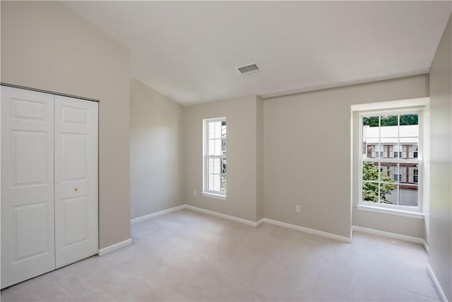 651 Village Green Blvd E, Adams Twp, PA 16046 - unfurnished bedroom with light carpet, lofted ceiling, and a closet