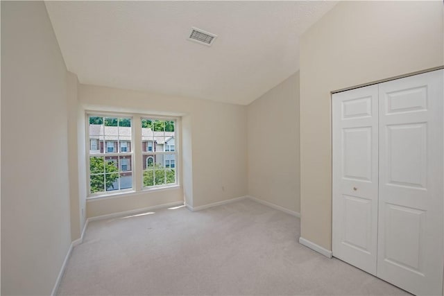 651 Village Green Blvd E, Adams Twp, PA 16046 - unfurnished bedroom featuring light carpet, a closet, and lofted ceiling