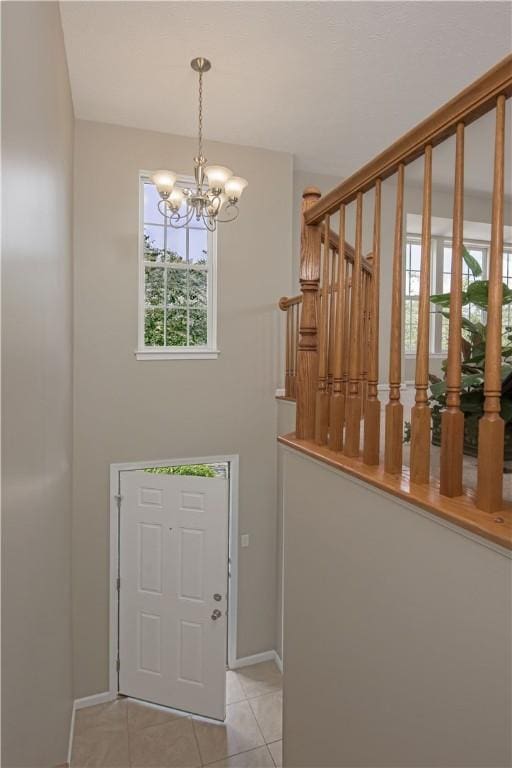 651 Village Green Blvd E, Adams Twp, PA 16046 - foyer featuring a chandelier, light tile patterned flooring, and stairs