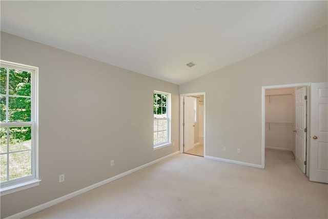 651 Village Green Blvd E, Adams Twp, PA 16046 - unfurnished bedroom with a walk in closet, vaulted ceiling, light carpet, connected bathroom, and a closet