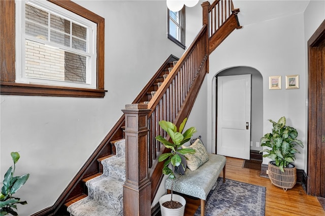 3238 Gaylord Ave, Dormont, PA 15216 - stairway featuring arched walkways, wood finished floors, and a towering ceiling