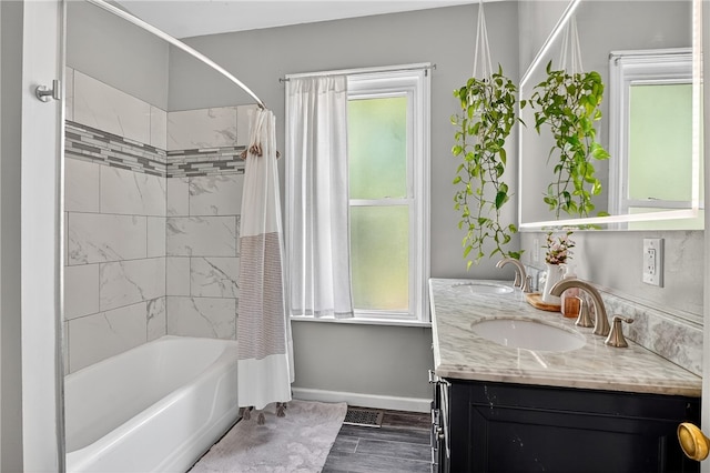 3238 Gaylord Ave, Dormont, PA 15216 - bathroom featuring double vanity, shower / bath combination with curtain, plenty of natural light, and wood finished floors