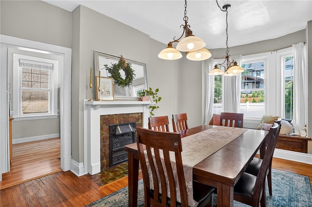 3238 Gaylord Ave, Dormont, PA 15216 - dining room with wood finished floors, a fireplace with flush hearth, and a chandelier