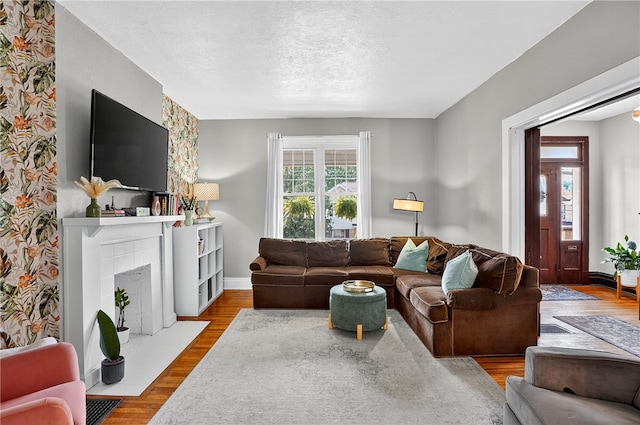 3238 Gaylord Ave, Dormont, PA 15216 - living area featuring a fireplace with flush hearth, wood finished floors, and a textured ceiling
