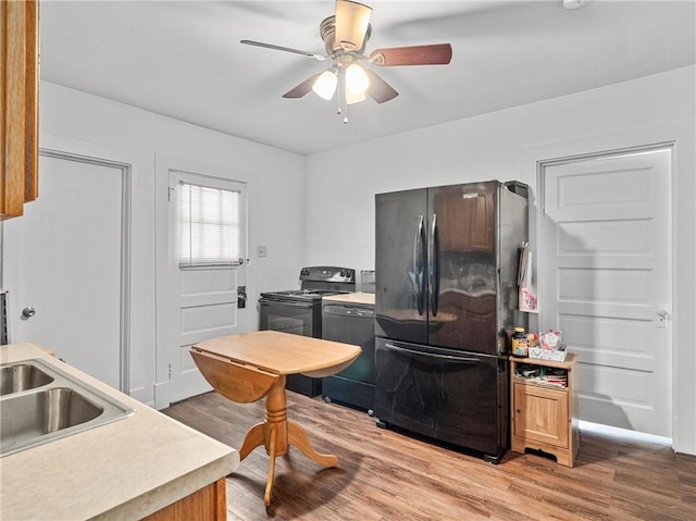 318 Penn Ave, Aliquippa, PA 15001 - kitchen with black appliances, light wood-style flooring, light countertops, and ceiling fan