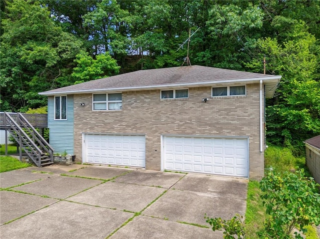 318 Penn Ave, Aliquippa, PA 15001 - view of front of property featuring brick siding, driveway, a garage, and stairs
