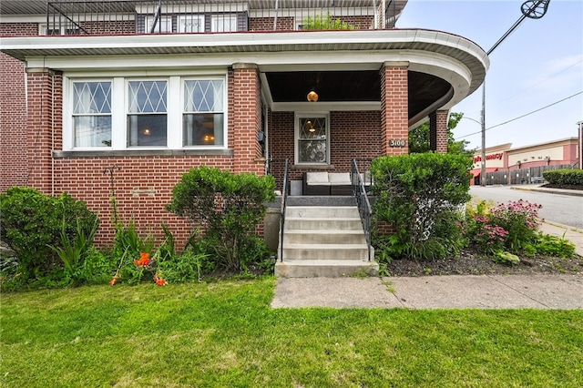 3100 Wainbell Ave, Dormont, PA 15216 - view of exterior entry featuring brick siding, a lawn, and a porch