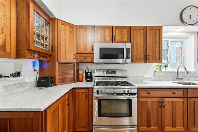 3100 Wainbell Ave, Dormont, PA 15216 - kitchen featuring stainless steel appliances, brown cabinets, and glass insert cabinets