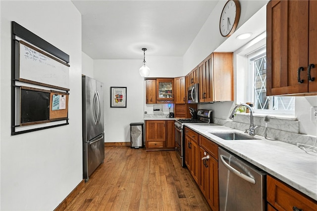 3100 Wainbell Ave, Dormont, PA 15216 - kitchen with appliances with stainless steel finishes, brown cabinetry, light countertops, dark wood-style flooring, and decorative light fixtures