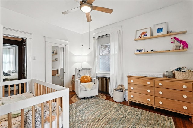 3100 Wainbell Ave, Dormont, PA 15216 - bedroom with radiator heating unit, a nursery area, dark wood-style floors, and ceiling fan