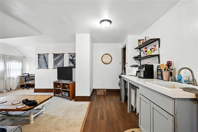 3100 Wainbell Ave, Dormont, PA 15216 - kitchen with white microwave, gray cabinetry, dark wood finished floors, light countertops, and open shelves
