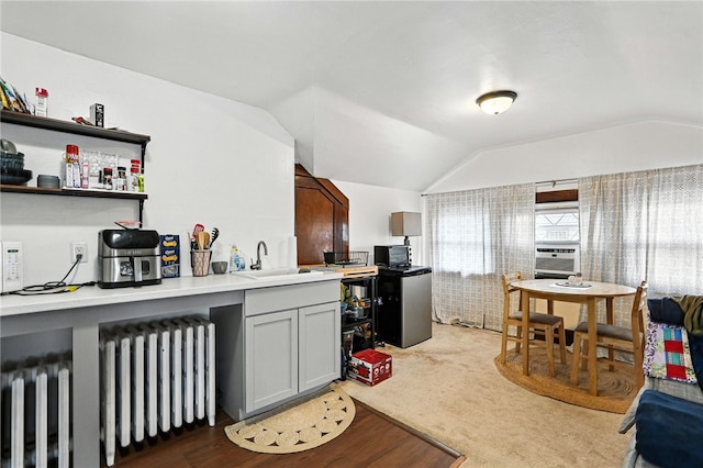 3100 Wainbell Ave, Dormont, PA 15216 - kitchen featuring radiator heating unit, lofted ceiling, light countertops, gray cabinetry, and cooling unit