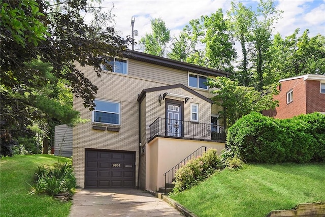 3931 Boulevard Dr, Squirrel Hill, PA 15217 - view of front facade with brick siding, a front lawn, concrete driveway, and a garage