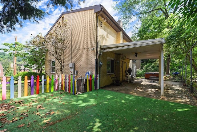 3931 Boulevard Dr, Squirrel Hill, PA 15217 - view of property exterior with a covered hot tub, brick siding, a lawn, a patio, and a chimney