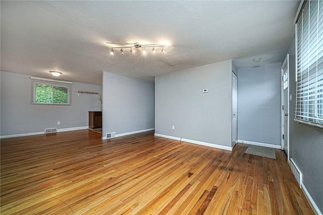 125 Holstein Dr, North Fayette, PA 15071 - unfurnished living room featuring wood finished floors and a textured ceiling
