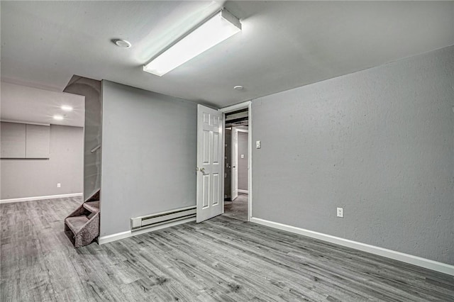 125 Holstein Dr, North Fayette, PA 15071 - spare room with a baseboard radiator, wood finished floors, and a textured wall