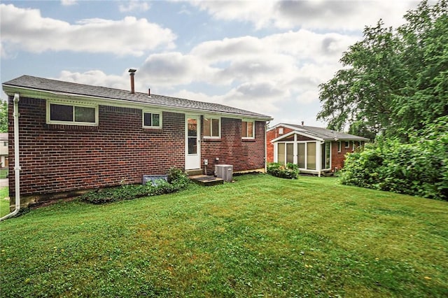 125 Holstein Dr, North Fayette, PA 15071 - back of property with brick siding, a lawn, and an outdoor structure